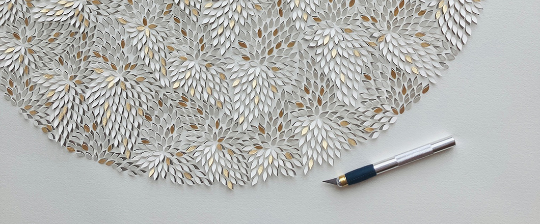 Delicate paper-cut floral art created with craft knife.