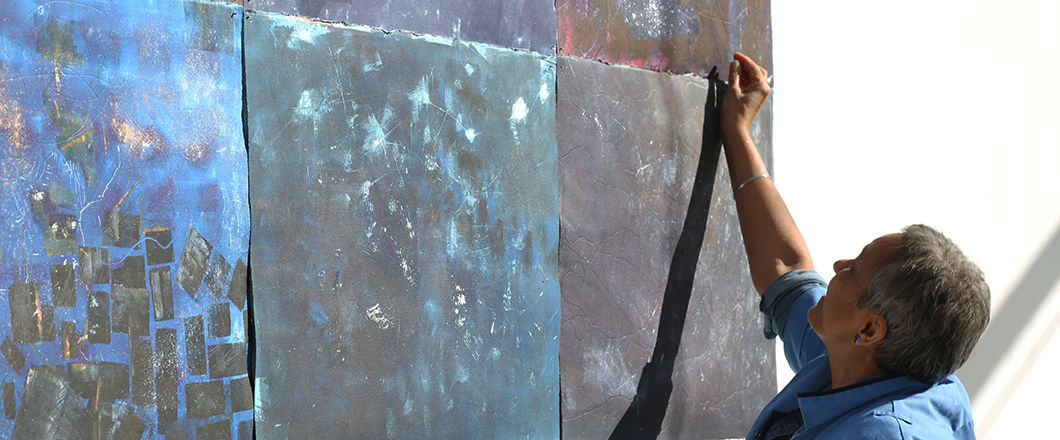 A person admiring and selecting a piece of art.