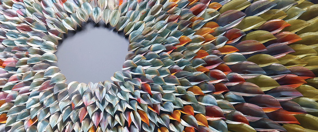 A 3D flower art piece, made up of individual flower petals, all created in muted spring tones.