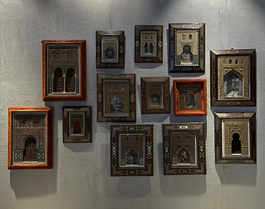 A collection of framed artwork, showcasing decorative archways from buildings around the world.